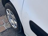 a white car that is parked on the side of the street