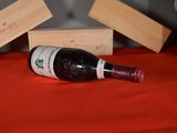 a bottle of wine sitting on a table next to wooden blocks