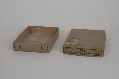 two empty boxes sitting on a white surface