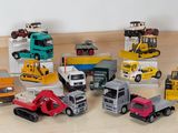 a lot of toy trucks that are sitting on the floor