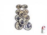 a lot of blue and white plates on a white surface