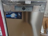 a silver dishwasher sitting on top of a cardboard box