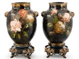 pair of antique vases with floral designs on them on stands