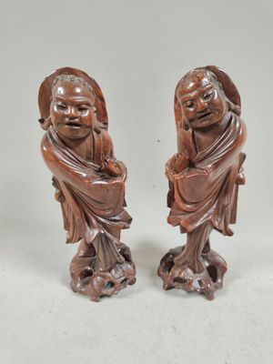 pair of chinese carved wood figurines of a man and a woman