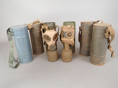 several different types of gas masks are lined up in a row