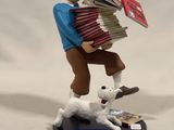 a figurine of a man playing an accordion with a dog