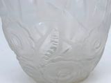 a white glass vase with a design on it
