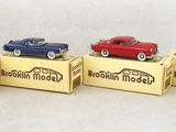 four toy cars are lined up in a row on display