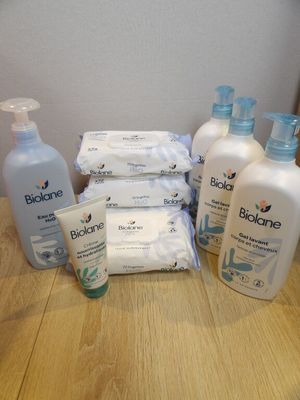 many bottles of lotion sitting on a table next to a bottle of lotion