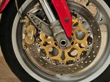 a close up of a motorcycle wheel with a red brake