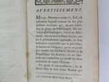 an open book on a white table with a black and white picture