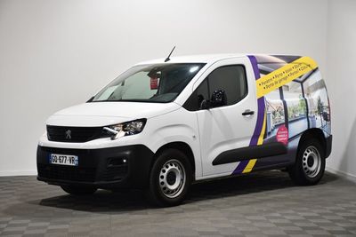 a white van parked in a room with a checkered floor