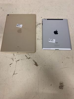 two ipads sitting next to each other on a table