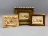 a group of three carved ivory plaques