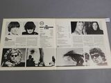 an open magazine with a bunch of pictures of people on it