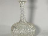 a clear glass bottle with a silver top