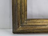an old gold frame with a white background and a white wall