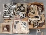 a plastic container filled with old photos and other items