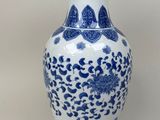 a blue and white vase sitting on a table