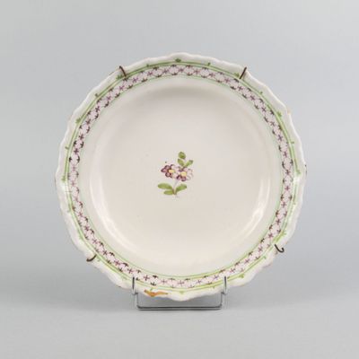 a close up of a plate with a flower design on it