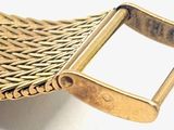 a close up of a gold belt with a metal buckle