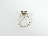 a close up of a diamond ring on a white surface