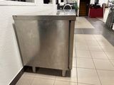 a stainless steel cabinet in the middle of a tiled floor