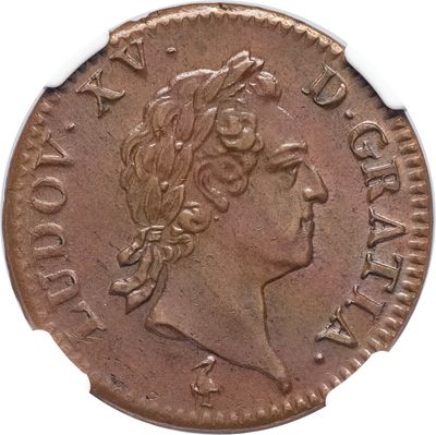gros plan d'une pièce de monnaie sur laquelle figure une tête de femme