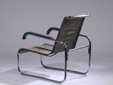 the chair is made of metal and has a leather seat