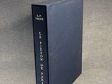 a black book sitting on top of a table next to a gray wall