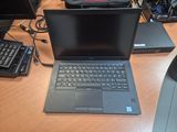 a laptop that is sitting on a desk next to a keyboard