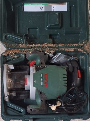 a green box with tools in it sitting on the ground