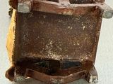 a small brown chair with a brown seat on a table