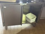 a stainless steel cabinet with a sink and a trash can in it