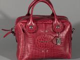 an image of a red purse sitting on top of a table