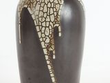 a black and white vase with a cracky design on it