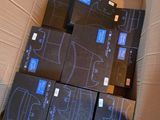 many boxes of electronic equipment in a box on the floor