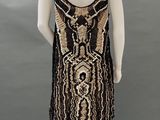 a black and gold beaded dress on a mannequin mannequin mannequin mannequin mannequin mannequin mannequin manne