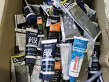 a cardboard box full of different types of paint