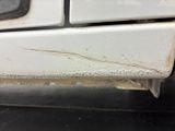 a dirty white oven with a black burner on it