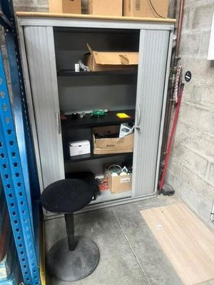 an image of a storage area with a table and a chair