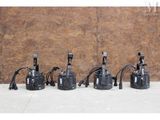 four different types of water pumps lined up against a wall
