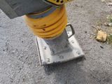 a close up of a yellow and black machine on the ground