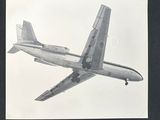 a black and white photo of an airplane flying in the sky