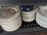 a lot of plates that are stacked up on a shelf