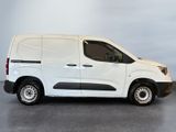 the white van is parked in a room with a gray floor