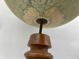a close up of a globe on a wooden stand