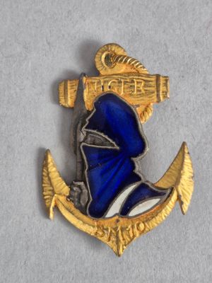 une image représentant une épinglette bleue et dorée sur laquelle figure un bonnet de marin