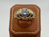a close up of a gold ring with a diamond on it