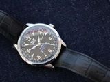 a watch that is sitting on a black leather strap
